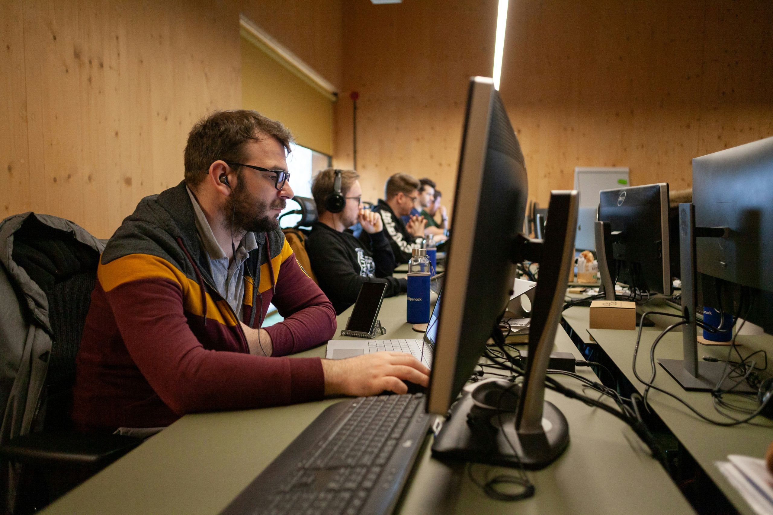 IT employees working in front of their stations in warmly-lit office